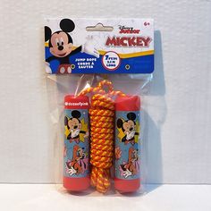 two mickey mouse toys are packaged in plastic