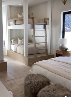 a bedroom with bunk beds and fur rugs on the floor