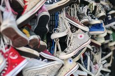 many pairs of shoes are stacked on top of each other