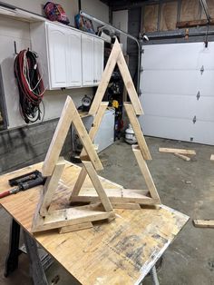 two wooden triangles are sitting on a workbench in front of a garage door