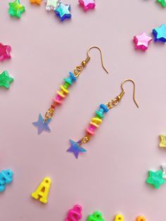 Shine like the star you are! Chasing down neon rainbows, living for intergalactic colors. These bright and pretty earrings feature soft plastic rings in neon rainbow colors with a fun and sparkly iridescent star charm. They hang on gold fish hooks and are the perfect compliment to your most colorful outfit. Bonus, they're ultra lightweight and comfortable to wear.  Measurements: 2 inches long Materials: Iridescent star charms, soft plastic beads, gold ear wires * Due to different settings on com Playful Bright Colored Jewelry Gift, Trendy Multicolor Star Jewelry, Playful Rainbow Jewelry For Festivals, Multicolor Star Charm Jewelry For Party, Trendy Rainbow Hypoallergenic Earrings, Fun Rainbow Jewelry For Pierced Ears, Colorful Star-shaped Jewelry For Gifts, Rainbow Plastic Party Jewelry, Handmade Rainbow Star Jewelry