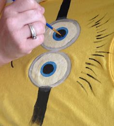 someone is painting an evil minion t - shirt