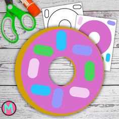 a pink donut cut out next to scissors and markers