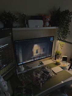 a desktop computer sitting on top of a desk next to a monitor and laptop keyboard