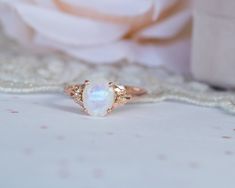 This is an oval moonstone ring, vintage style moonstone engagement ring, solitaire ring, moonstone engagement ring, gemstone ring, moonstone gold ring, oval engagement ring, a perfect moonstone engagement ring. This vintage style floral ring and has a dainty and feminine design, a solitaire vintage style with a natural oval rainbow moonstone, that symbolizes passion and endless love. This unique engagement ring is the best way to show your pure love for the one you love. ♥ Moonstone Gemstone mea White Oval Moonstone Ring With Rose Cut Diamonds, White Oval Moonstone Ring With Center Stone, White Oval Moonstone Ring For Wedding, White Oval Moonstone Wedding Ring, Oval Moonstone Fine Jewelry Ring, Fine Jewelry Oval Moonstone Ring, Oval Moonstone Promise Ring With Center Stone, Elegant Oval Moonstone Ring, Oval Moonstone Wedding Ring Fine Jewelry