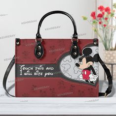 Touch This and I will Bite You Leather Handbag,Woman Handbag,Mickey Women Bags Purses,Mickey Lover's Handbag,Custom Leather Bag,Handmade Bag Product Information: Manufactured with premium water-resistant PU leather. Size: ~11.4*7.9*4.1in (29*20*10.5 cm). Features comfortable and sturdy ~29in (74cm)carrying straps, two handles~14,5in (37cm) high-quality stitching for long-lasting durability. Perfect for dating, shopping, working, traveling, vocation, party and other occasions. Well made of high quality metal buckle. Detailed stitching with smoothly metal buckle. Handbags have 1 main compartment, and one side pocket - you can use it for an extra pocket. This handbag can hold your iPad, wallet, makeup, phone, little water bottle, perfumes, gloves, and other everyday items and keep them organi Custom Leather Bag, Leather Bag Handmade, Woman Handbag, Leather Handbags Women, Handmade Bag, Leather Bags Handmade, Timeless Accessories, Bag Handmade, Bags Purses