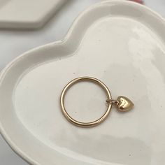 Our Dangling Heart Ring ring is sweetness in a ring, you'll love looking at it all day long while going about your business... wear it in a fun stack or if you're a lover of all things minimalistic you'll rock it alone. Each and every ring is hand-made in our studio at the time of order in sterling silver or 14kt gold fill gold filled wire and features a gorgeous 6mm dangling puffy heart charm. You're going to love creating your custom stack! All of our rings are handmade to order just for you i Puffy Heart Charms, Stone Feature, Business Wear, Puffy Heart, Gold Filled Jewelry, Caicos Islands, Seychelles, Ring Ring, 14kt Gold