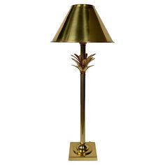 a brass lamp with a gold shade on it's base and a pineapple design