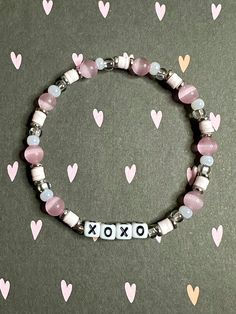 XOXO beaded stretch bracelet in a girly pink aesthetic vibe.  Bracelets are available in a variety of lengths.  Pick your custom length from the drop down menu below.  Please be aware that beading may slightly differ from what is pictured as to accommodate selected sizing.  All our bracelets are made with quality in mind.  With that being said, all bracelets should be treated with care while putting on, wearing, and taking off.  Keep dry. Do not swim or bath with them. Personalized Pink Beaded Bracelets For Valentine's Day, Personalized Pink Friendship Bracelets For Valentine's Day, Cute Stretch Bracelet With Letter Beads For Valentine's Day, Cute Letter Beads Stretch Bracelet For Valentine's Day, Pink Beaded Bracelets With Letter Beads For Valentine's Day, Pink Stretch Bracelet With Letter Beads For Valentine's Day, Pink Beaded Bracelet With Letter Beads For Valentine's Day, Cute Pink Stretch Bracelet For Valentine's Day, Valentine's Day Pink Stretch Bracelet With Heart Beads