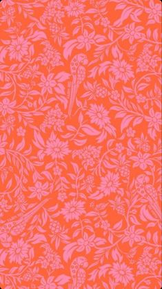 an orange and pink background with flowers