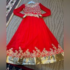 Beautiful Bright Red Color With Golden Color Detail Embroidery Worn Once Has A Light Stain But Other Than That It’s In Great Condition (See Video For Details) Final Sale No Returns Open To Offers Women’s Size Small One Piece Long Anarkali Traditional Red Floor-length Dress, Eid Festive Dresses With Gold Embroidery, Red Floor-length Dresses For Eid, Traditional Red Dresses For Eid, Floor-length Red Dress For Eid, Festive Gold Embroidered Dress For Eid, Semi-stitched Dresses With Gold Embroidery For Diwali, Red Anarkali Dress For Eid, Red Traditional Dress For Eid