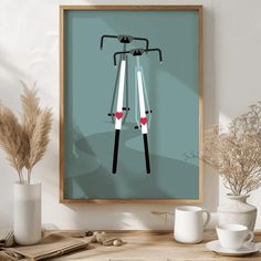 a framed poster with two bicycles on the front and back, sitting on a table