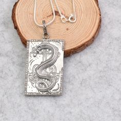 Silver Dragon Pendant Necklace, Chinese Dragon Pendant Charm, Minimalist Dragon Necklace, Necklace For Boyfriend, Diamond Dragon Necklace  Description : This captivating silver necklace features a rectangular pendant adorned with a mesmerizing dragon design. The intricate details of the dragon, from its scales to its claws, are brought to life with expert craftsmanship. The dragon is surrounded by a border of sparkling pavé diamonds, adding a touch of luxury and elegance. The pendant is suspende Diamond Dragon, Necklace For Boyfriend, Boyfriend Necklace, Dragon Necklace, Silver Dragon, Dragon Pendant, Dragon Design, Chinese Dragon, Necklace Necklace