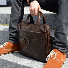 Fashioned from high-quality chestnut brown cow leather, this masculine beauty comes with plenty of space for your laptop, documents, books, and more. Inside, you'll find 1 large central compartment and a padded pocket for safely carrying your laptop, as well as smaller pockets for phones, keys, and your wallet. On the back, there's a neat quick access pocket, as well as 3 pockets in front, two with zippers. No more running out of space. Reinforced stitching on the adjustable shoulder strap and the top handles means you can carry all your personal items safely. Brown Business Laptop Shoulder Bag, Professional Brown Laptop Bag For Everyday Use, Brown Business Bag With Laptop Sleeve, Brown Shoulder Laptop Bag For Business, Professional Brown Leather Satchel, Professional Brown Leather Laptop Bag, Professional Brown Satchel For Everyday Use, Brown Shoulder Bag With Laptop Sleeve For Business Trips, Professional Brown Rectangular Bag