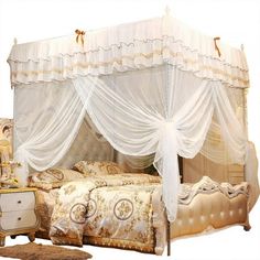 a bed with white drapes on top of it next to a dresser and chair