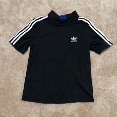 Never Worn Casual Black T-shirt With Three Stripes, Basic Short Sleeve Tops With Three Stripes, Basic Adidas Tops With Three Stripes, Classic Crew Neck Top With Three Stripes, Classic Black Top With Graphic Print, Adidas Short Sleeve Tops With Three Stripes, Basic Adidas Tops For Streetwear, Classic Adidas Short Sleeve Tops, Classic Black Tops With Logo Print