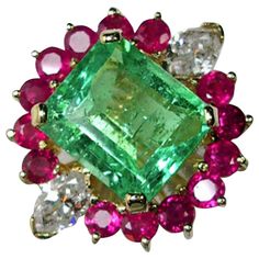 This beautiful 18K yellow gold cluster cocktail ring centers a beautiful Colombian emerald and is dramatically adorned with rubies and diamonds. Primary Stone: Natural Colombian Emerald (Minor Oiled) Shape Or Cut: Emerald Cut Emerald Weight: 5.00 Carats (1 Emeralds) Treatment: No Heat ~ Only Oil Average Color/clarity Emerald: Medium Light Green/vs (Very Clean)) Accent Stones: Genuine Diamond Shape Or Cut Diamond: 2 Marquise Cut Average Color/clarity Diamond: F-G/VS1-VS2 Total Diamond Weight: Ove Black Gold Jewelry, Green Ring, Contemporary Ring, Pink Men, Colombian Emeralds, Men Ring, Expensive Jewelry, Ruby Jewelry, Emerald Jewelry