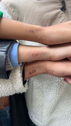 Three siblings wrist showcasing matching tiny tattoo Line Tattoos Family, Tattoos To Get For Siblings, Cute Matching Tattoos For Siblings, Tattoo Ideas For Triplets, Tattoos For My Siblings, Trio Tattoo Ideas Siblings, Two Siblings Tattoo, Matching Tattoos For 3 Cousins, Tiny Tattoos Siblings