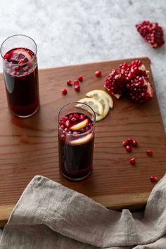 two glasses of pomegranate on a cutting board