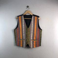 "PLEASE READ DESCRIPTION BELOW BEFORE BUYING👇🏻 *ITEM:Vintage Nepal Vest *ITEM DETAILS: 👇🏻 Please be aware that all vintage items will usually show a few signs of wear or fading due to age, but anything visible such as stains or holes, and serious flaws have been photographed.For any further information on this item please contact us and we will be happy to help. *SIZE:MEDIUM *ACTUAL SIZE MEASUREMENT: 👇🏻 *PIT TO PIT(WIDTH):21\"INCHES *LENGTH(FROM SHOULDER): 24\"INCHES *ALL MEASUREMENTS ARE Multicolor Cotton Winter Vest, Multicolor Patchwork Sleeveless Vest, Orange Sleeveless Winter Vest, Winter Orange Sleeveless Vest, Multicolor Patchwork Vest For Summer, Multicolor Sleeveless Cotton Outerwear, Fitted Multicolor Casual Vest, Sleeveless Multicolor Cotton Outerwear, Casual Fitted Multicolor Vest