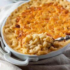 a baked macaroni and cheese pie with a serving spoon