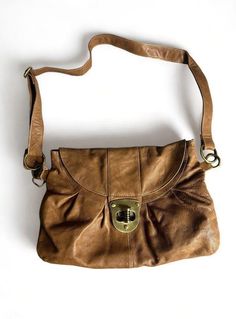 This vintage Aldo women's shoulder handbag is a stylish addition to any wardrobe. Crafted from high-quality leather, this medium-sized bag is perfect for everyday use. The exterior features a beautiful brown color that complements any outfit, making it a versatile accessory. The bag is designed with a shoulder strap for easy carrying and comes in a stylish Aldo brand. It's perfect for women who want a chic and practical accessory. Whether you're running errands or going out for a night on the town, this bag is sure to impress. Please look at the pictures for sone flaws and also inside bag theres a minor stain that can potentially be cleaned but I didnt try. Message me if you have any questions. Brown Handheld Satchel For On-the-go, Vintage Hobo Bag With Detachable Handle For Everyday, Retro Brown Hobo Bag For Daily Use, Vintage Brown Hobo Bag For Everyday, Retro Brown Hobo Bag In Tote Shape, Brown Vintage Hobo Bag With Double Handle, Brown Retro Hobo Bag For Everyday Use, Vintage Brown Bag For Fall, Retro Vintage Brown Soft Leather Bag