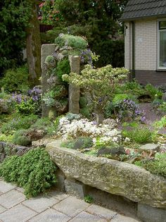 a stone bench sitting in the middle of a garden