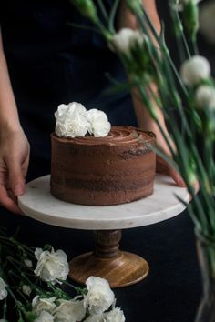 a chocolate cake with white flowers on top