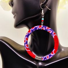 "These vibrant authentic African hand-crafted hoop earrings are the perfect addition to your wardrobe and perfect unique gift for her! Size: 3\" Color: Purple & Red Shape: Round Material: African Ankara fabric with hypoallergenic silver earring hooks. Due to screen resolution, color may appear different than the actual product. Fabric patterns may not look identical due to variances in fabric prints. Each pair may look slightly different from the one pictured, which gives you unique custom beautiful earrings hand-crafted just for you! check out our shop for more African inspired fashion and accessories. https://www.etsy.com/your/shops/NicolorByNicole/ follow us on Instagram for fun behind the scenes! https://www.instagram.com/nicolorfulness/ Thank you for visiting NicolorByNicole. If you h Fabric Hoop Earrings, Red Hoop Earrings, African Earrings, African Ankara, Fabric Prints, African Inspired Fashion, Earrings Purple, Ankara Fabric, Unique Gifts For Her