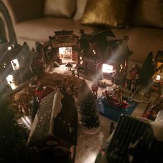 a living room filled with lots of toys and christmas decorations on top of a table