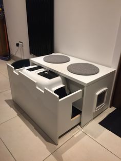 a dog house with two dogs in it's storage compartment and the door open