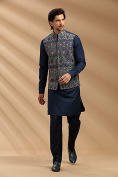 Top Details Color- Navy Blue, Fabric - Soft Suiting Fabric With Embroidered Bottom Details Color- Black, Fabric - Suiting Fabric, Style - Aligadi Pajama Package Include :INCLUDES 1 BANDI,1 KURTA,1 ALIGADI. Turban ,Mojari And Other Accessories Are Not Sold Along With The Dress. CARE: DRY CLEAN ONLY Additional Information : - As This Sherwani/Waistcoat/Kurta Are Made As Per Orders So It Is Strictly Not Acceptable Once Get Delivered .So Kindly Choose Body Fit Size . Also We Keep 2 Inches Extra Margin In The Dress. Unstitched Blue Nehru Jacket With Dabka, Blue Unstitched Nehru Jacket With Dabka, Blue Nehru Jacket With Pallu For Eid, Blue Nehru Jacket With Chikankari Embroidery For Festivals, Traditional Blue Nehru Jacket In Straight Kurta Style, Blue Nehru Jacket Straight Kurta For Festivals, Blue Nehru Jacket For Festivals, Straight Kurta Style, Traditional Unstitched Blue Nehru Jacket, Blue Nehru Jacket With Resham Embroidery For Diwali