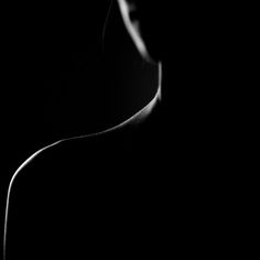 black and white photograph of a woman's face in the dark