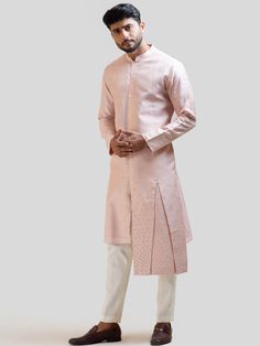 This Onion Pink Embroidered kurta set will instantly give an elegant look. This 2 piece kurta set features an onion pink bam silk kurta with box pleat detail on high and low panels, butti embroidery, front buttons fastening, and a mandarin collar. It is paired with narrow fitted pajama pants in cream color and malai cotton fabric. An ideal outfit for traditional occasions, and special events.

Size Chart For Men





	
	
					Men's Size Chart
		

		
		
						
				Size Chart For Men
				Custom Si Butti Embroidery, Onion Pink, Silk Kurta, Box Pleats, Kurta Set, Mandarin Collar, Cream Color, 2 Piece, High & Low