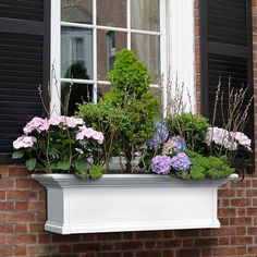 a window box filled with lots of flowers