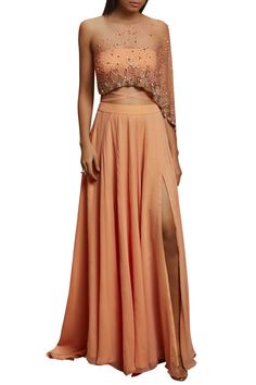 Peach crop top with attached drape paired with matching flare long skirt.
Components: 2
Fabric: Georgette,net,crepe
Color: Peach
Cutdana,sequins,salli embroidery
Top: Back tie-up details,one side extended sleeves
Closure: Skirt: Side zip - Aza Fashions Floor-length Georgette Party Skirt, Georgette Long Skirt For Reception, Elegant Georgette Skirt Set For Party, Long Georgette Skirt For Party, Party Long Georgette Skirt, Elegant Floor-length Georgette Skirt Set, Elegant Orange Party Sets, Elegant Summer Evening Lehenga, Elegant Summer Floor-length Lehenga