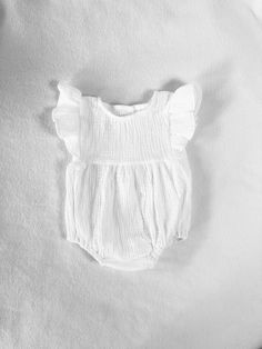 This 100% cotton double gauze romper is perfect addition to your little one's outfit. Lightweight double gauze is so flowy and soft. The outfit is HAND-MADE, Made to order item. It is made in Sunny California, in USA. All items are professionally serged and finished for quality and durability. If you need some customization, feel free to contact us. We also offer the Mary Jane shoes and cotton cable socks that go perfectly with the romper. Here is the link to shoes: https://www.etsy.com/Melodyan Summer Vacation Bubble Romper With Ruffles, White Cotton Beach Jumpsuits And Rompers, White Cotton Jumpsuits And Rompers For Beach, Cute Ruffled Bubble Romper For Vacation, Cute Bubble Romper With Ruffles For Vacation, White Cotton Jumpsuits And Rompers For Vacation, Summer Bubble Romper With Ruffles For Beach, Spring White Bubble Romper For Beach, White Spring Bubble Romper For Beach