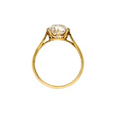 a gold ring with an oval cut diamond in the center and two small round diamonds on each side