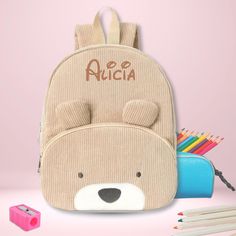 introducing our Personalized Corduroy Backpack for Kids, the perfect blend of style and functionality for your little one's school essentials.  Made from soft, high-quality corduroy, this backpack is designed to withstand the hustle and bustle of a child's daily activities while providing a comfortable carry. Features: ADORABLE DESIGN: The different animal faces on the front pocket adds a playful and charming touch, making it an instant favorite among kids. PERSONALIZED TOUCH: Customize it with Cute School Backpack With Animal Design, Back To School Backpack With Animal Design, Student Backpack With Animal Design For Back To School, Back To School Backpack With Animal Design For Students, Back To School Student Backpack With Animal Design, School Backpack With Animal Design, School Bags With Animal Design For Back To School, Corduroy Backpack, Kids Teddy Bear