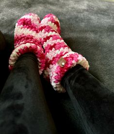 Keep your feet warm and cozy with these fuzzy pink slippers. Made from soft and comfy material, these socks are perfect for lounging around the house or keeping your toes toasty on a chilly day. Cozy Handmade Winter Slippers, Comfy Snug Pink Socks, Pink Comfortable Winter Slippers, Comfortable Pink Winter Slippers, Comfortable Soft Pink Socks, Cozy Yarn Slippers With Round Toe, Cozy Super Soft Slippers For Home, Cozy Crochet Slippers For Winter, Handmade Cozy Yarn Slippers