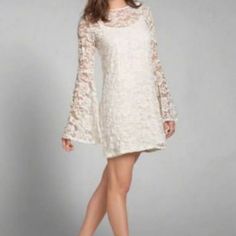 Beautiful Lace Bell Sleeves Dress With Under Slip. Adjustable Straps. Chest 16 1/2 In. Length From Shoulders 30 1n. Chic Spring Dress With Lace Sleeves, Spring Flowy Lace Dress With Lace Sleeves, Flowy Spring Lace Dress With Lace Sleeves, Flowy Lace Dress With Lace Sleeves For Spring, White Lace Dress For Fall, Flowy Lace Dress For Party, White Lace Dress With Lace Trim For Fall, Spring Mini Lace Dress With Lace Sleeves, Spring Lace Dress With Lace Sleeves And Mini Length