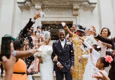 a bride and groom are showered with confetti