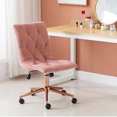 a pink office chair sitting in front of a desk with a mirror on top of it