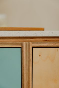 a close up view of the top of a cabinet with glass doors and wood trim