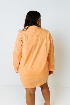 Channel all the good luck on your special day with this casual cute orange plus size top featuring lightweight material, a button up front with a collared neckline, long loose sleeves with roll tab cuffs, a single accent chest pocket, and a relaxed silhouette that falls into a rounded hemline!   Measurements 1XL variant has  a Bust of 58",  a Hip of 54",  a Length of 35",  a Sleeve Length of 15",  a Waist of 53".  2XL variant has  a Bust of 60",  a Hip of 55",  a Length of 36",  a Sleeve Length Oversized Long Sleeve Orange Blouse, Oversized Orange Long Sleeve Blouse, Long Sleeve Peach Blouse For Fall, Peach Long Sleeve Blouse For Fall, Orange Long Sleeve Blouse With Relaxed Fit, Orange Fall Blouse For Daywear, Fall Orange Blouse For Daywear, Orange Relaxed Fit Long Sleeve Blouse, Accent Chest