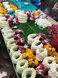 many flowers are laid out on the ground to be used as decorations for an event