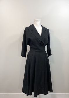 "Elegant black raw silk dress with great 1950s details. Lovely silhouette with one large button (and a bound buttonhole!) on the bodice as well as snaps and hooks inside. The collar and lapel are wide and fantastic. 3/4 dolman sleeve. Waist seam with pleats at the side front and back panels but flat in the front. The lining is a cheerful pale yellow silk. No label, handmade. Condition is great. The lining has some stains and discoloration as well as holes from wear and age under each underarm. R Formal Vintage Dress With Full Skirt, Vintage A-line Dress For Work, 1950s Style Formal Dresses With Buttons, 1950s Style Buttoned Dresses For Work, 1950s Style Vintage Dress For Work, 1950s A-line Vintage Dress, Retro Evening Dresses With Buttons, Vintage Evening Dresses With Buttons, Raw Silk Dress