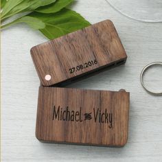 two personalized wooden keychains sitting next to each other