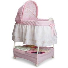 a pink baby crib with a bed underneath it