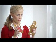 a woman is holding two gingerbreads in her hands